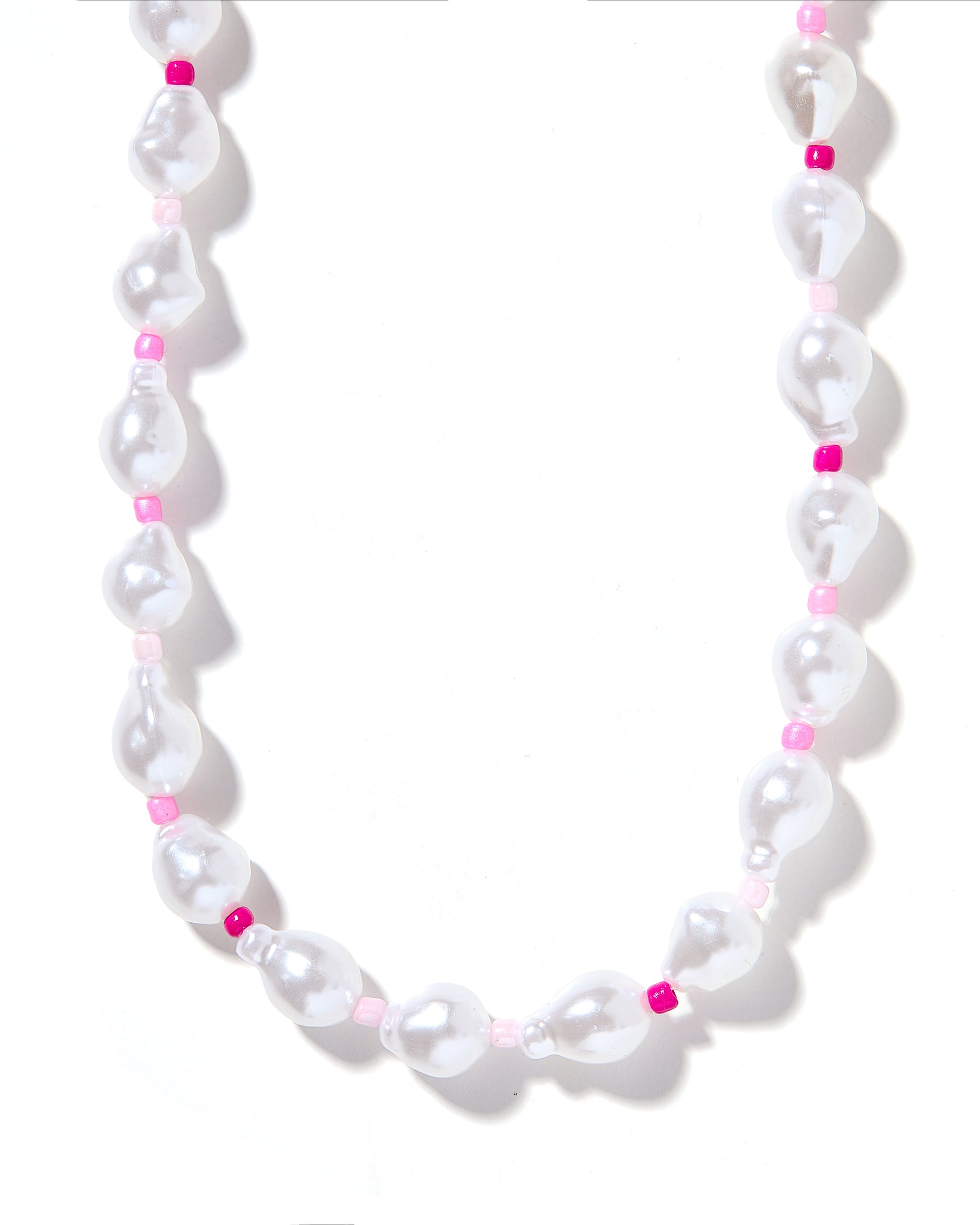 A necklace with white pearls and pink beads, strung together on a string.