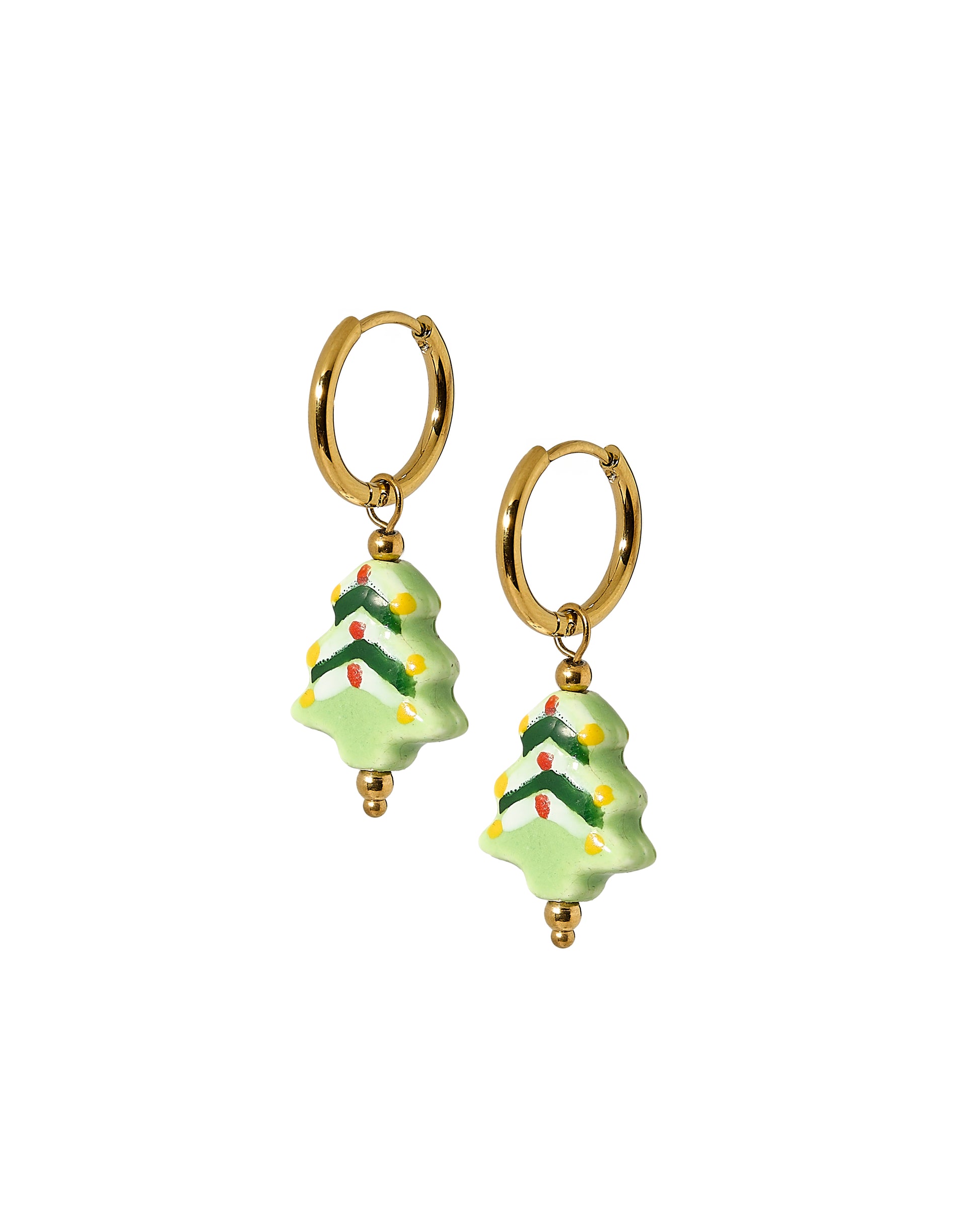 Gold hoop earrings with Christmas tree-shaped charms on a white background