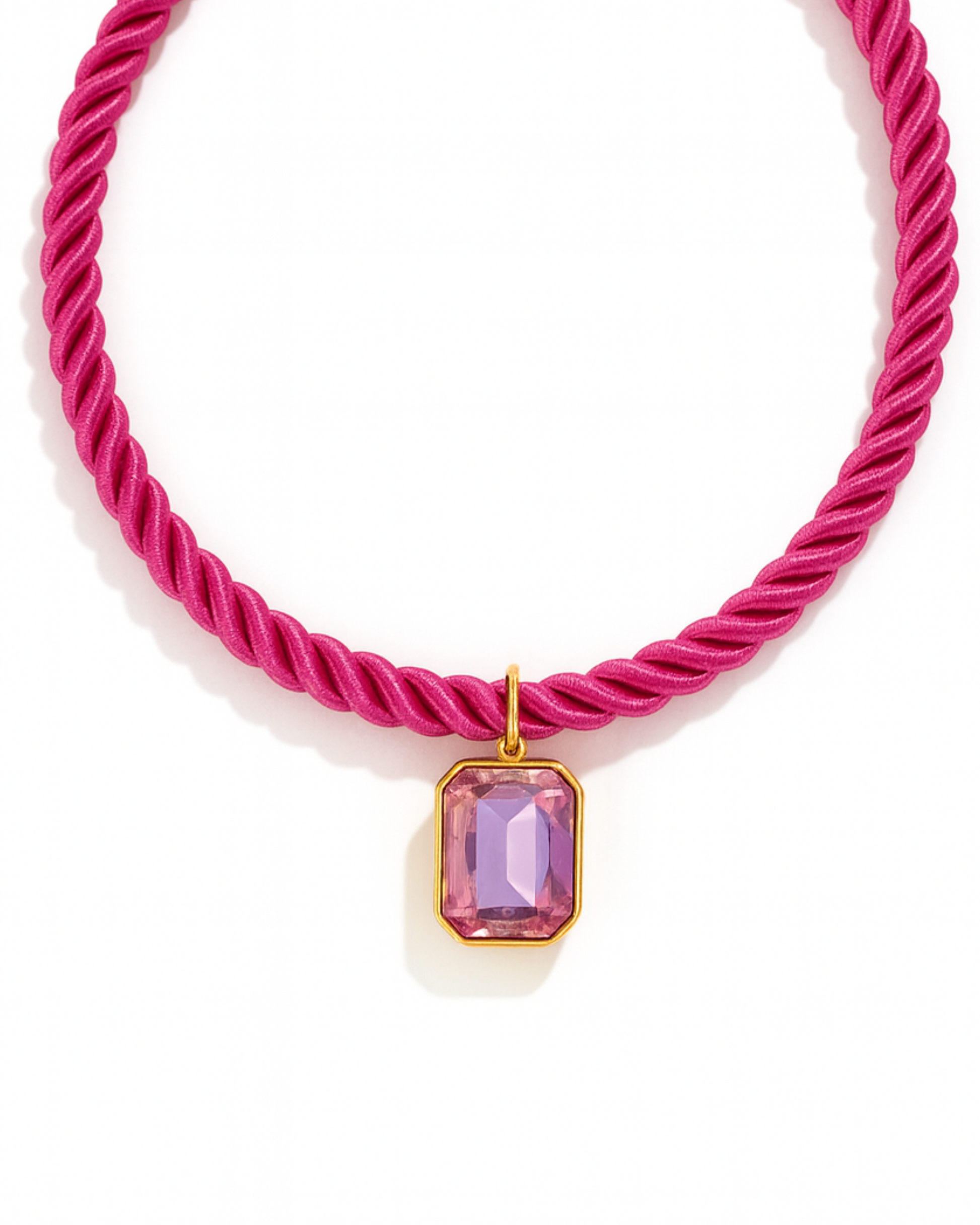 Pink rope necklace with a pink gemstone pendant on a white background