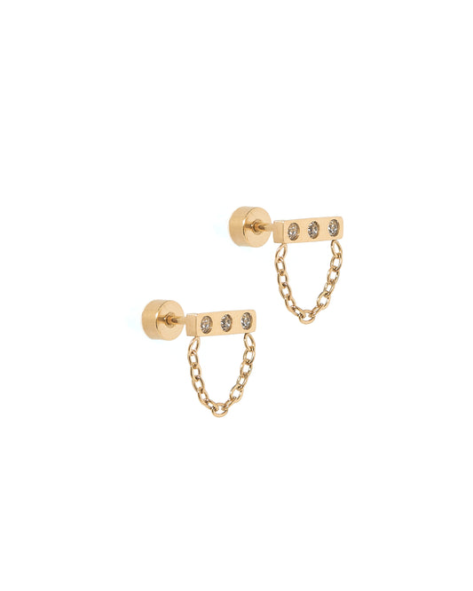 A pair of gold-colored screwback stud earrings with a horizontal bar design featuring CZ stones and a dangle chain.