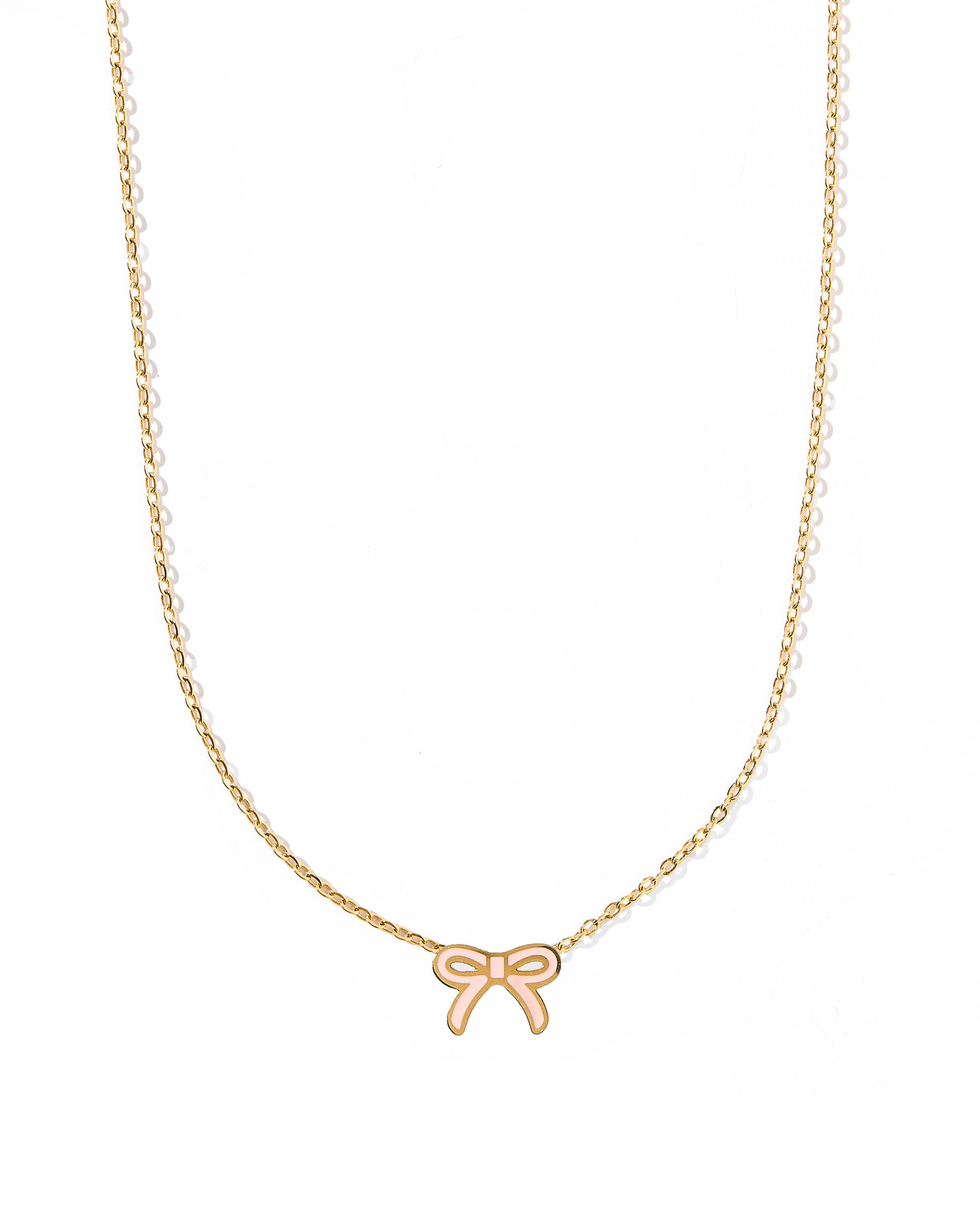A thin gold bow pendant necklace with a light pink accent on a white background.