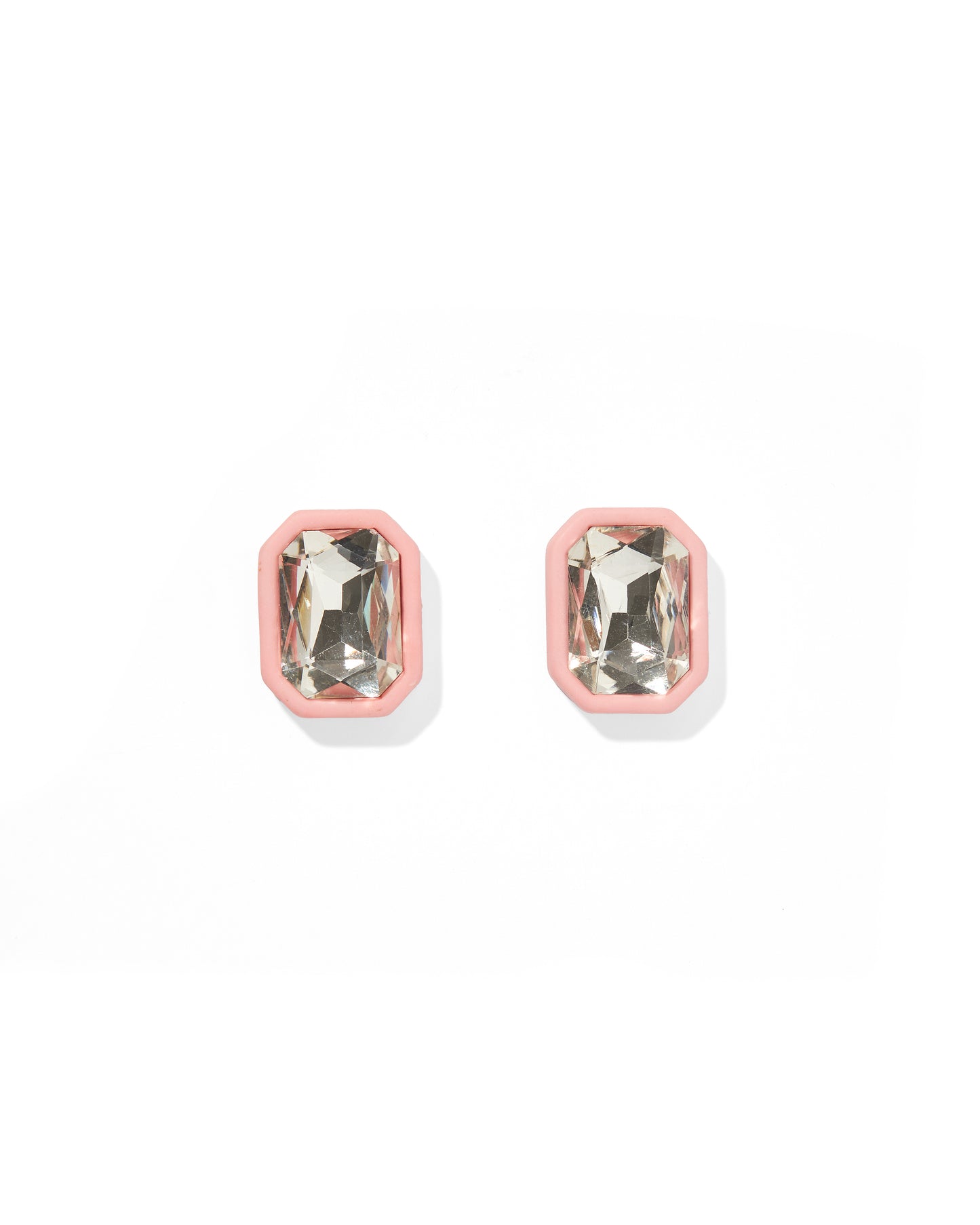 Pair of earrings with pink and clear gemstones on a white background