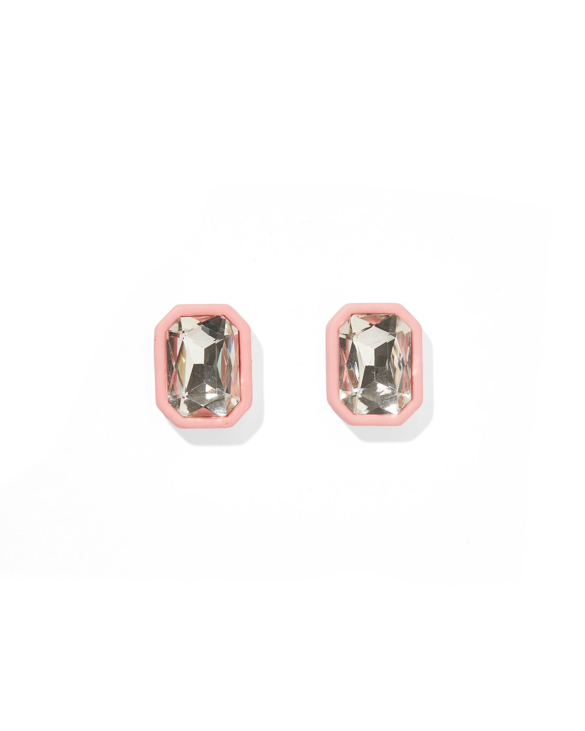 Pair of earrings with pink and clear gemstones on a white background