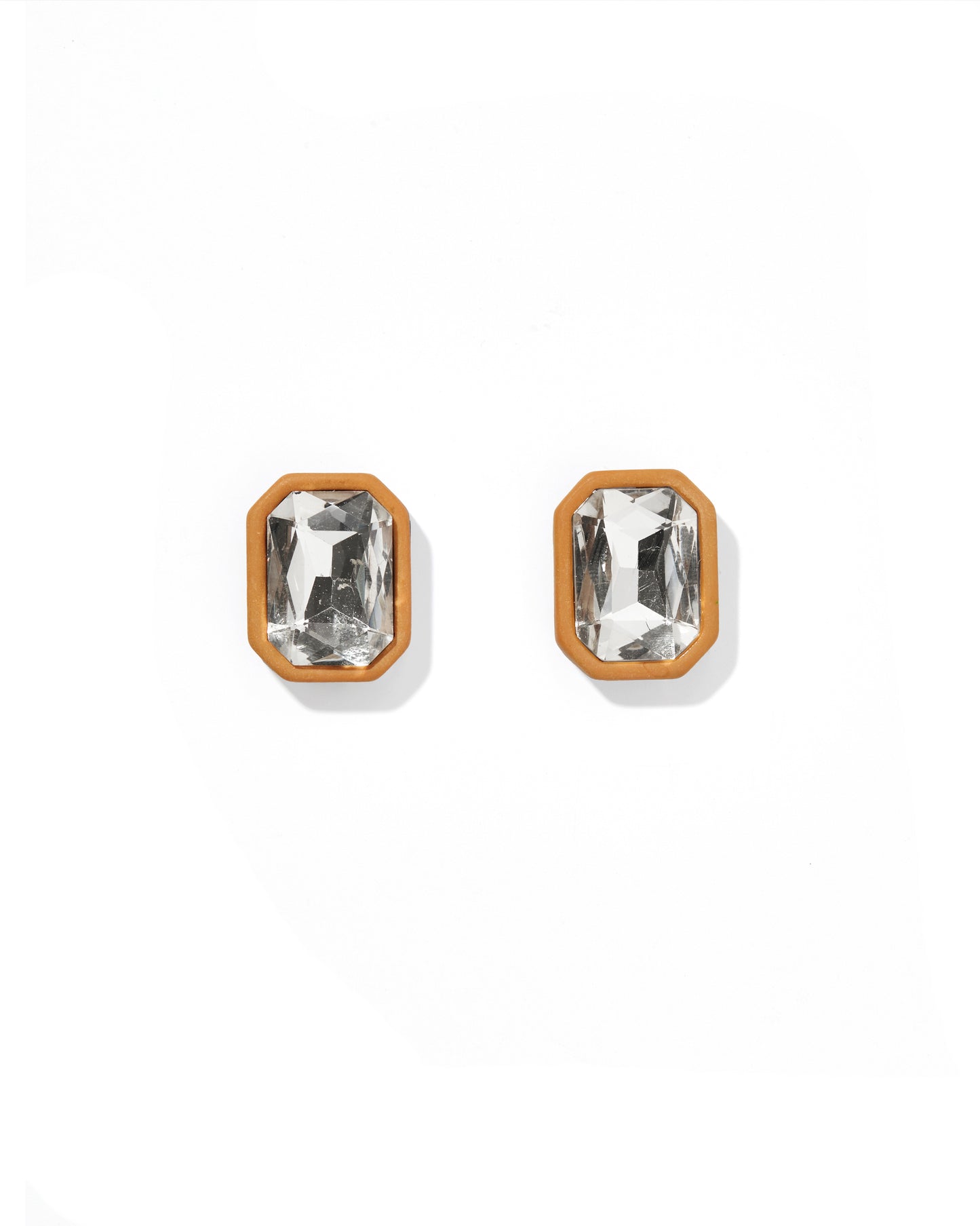 Pair of gold-framed crystal stud earrings on a white background
