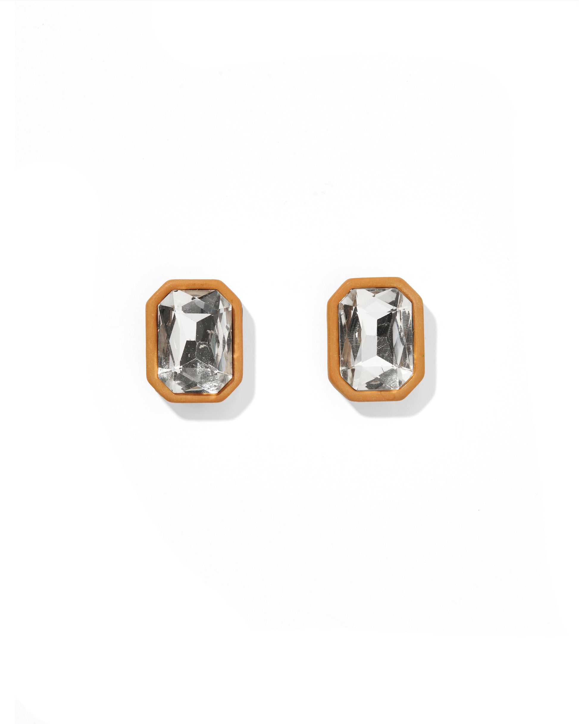 Pair of gold-framed crystal stud earrings on a white background
