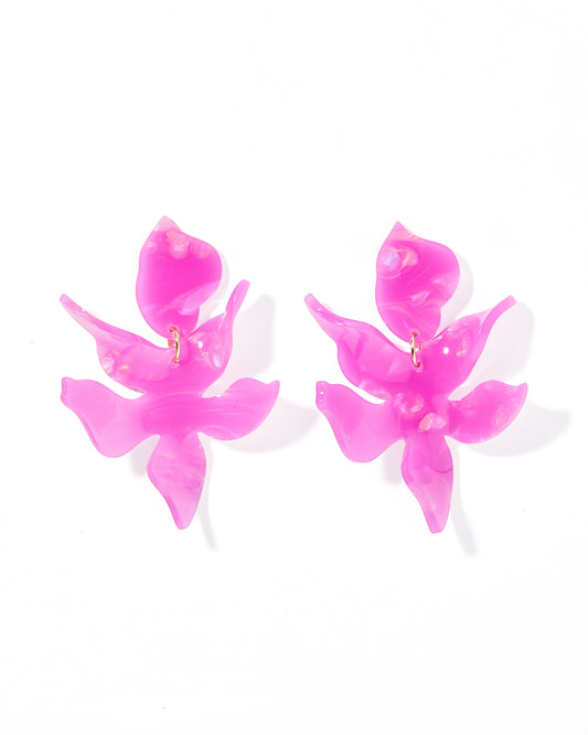 A pair of oversized, magenta-purple floral statement earrings
