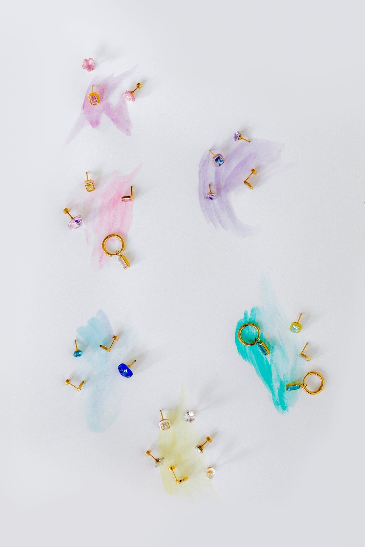 LINNY CO Edith Pink Gold huggie earrings for kids & little girls — hypoallergenic, waterproof stainless steel, flat-lay styling.