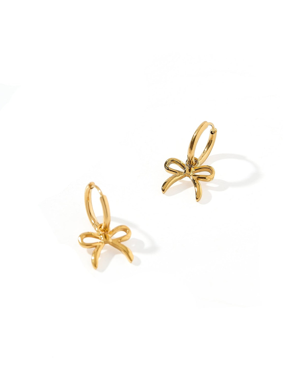 LINNY CO Sadie Bow Gold huggie earrings for kids & little girls — hypoallergenic, waterproof stainless steel, detail.