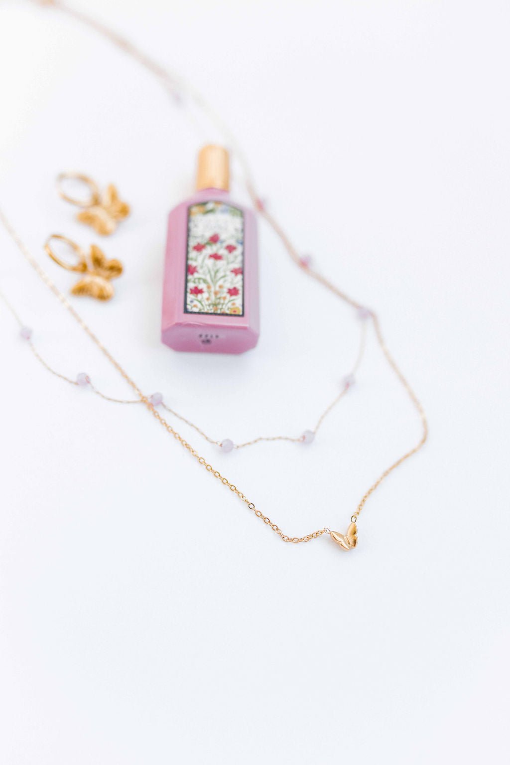 LINNY CO Bella Butterfly necklace for kids & little girls — hypoallergenic, waterproof stainless steel, flat-lay styling.