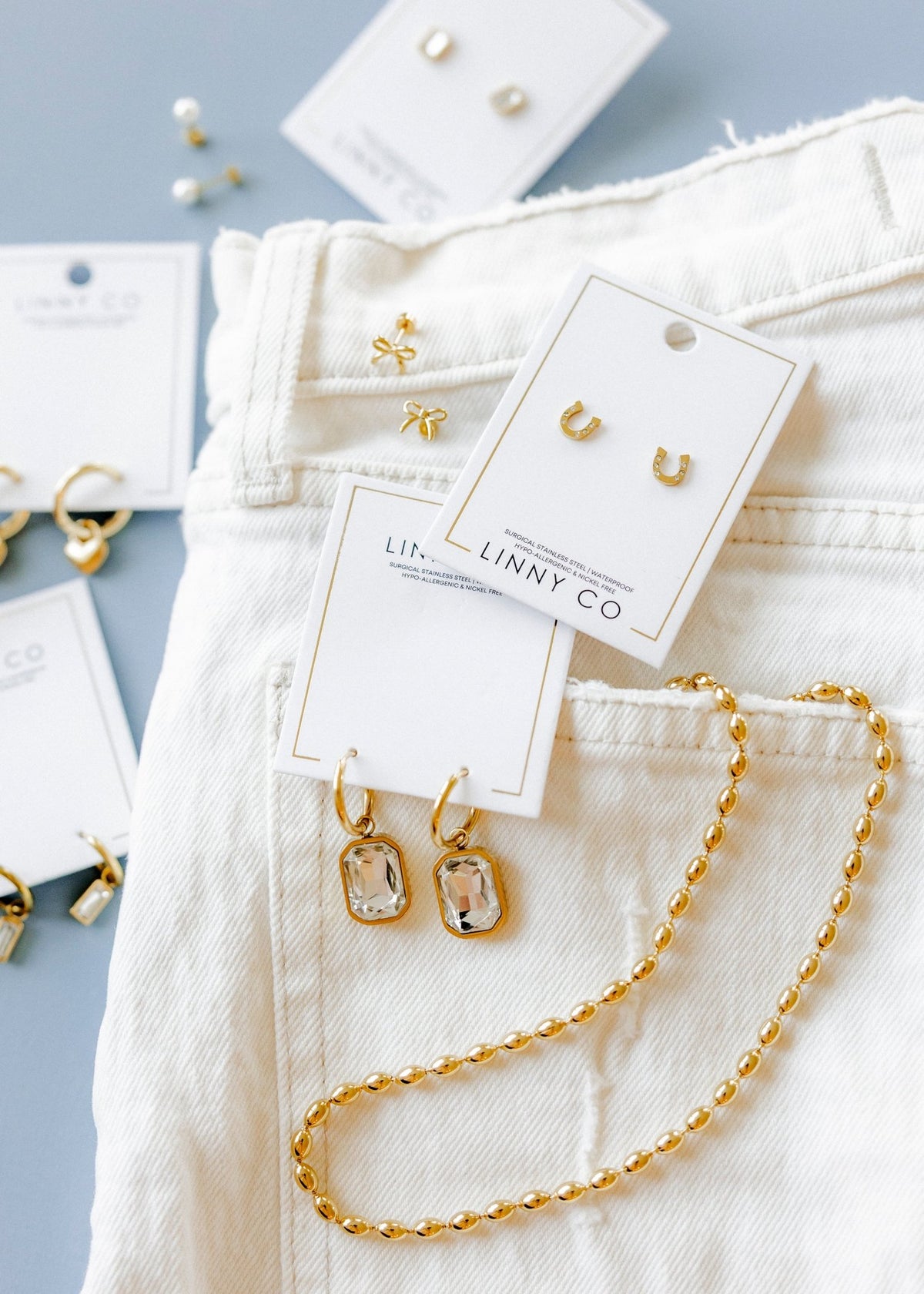 LINNY CO Brooke Gold necklace for kids & little girls — hypoallergenic, waterproof stainless steel, flat-lay styling.