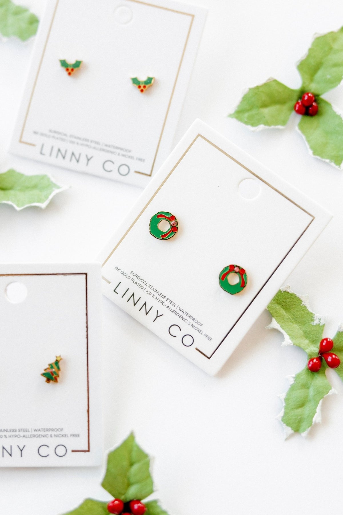 LINNY CO Leighton Wreath screwback stud earrings for kids & little girls — hypoallergenic, waterproof stainless steel with secure screwback backs, flat-lay styling.
