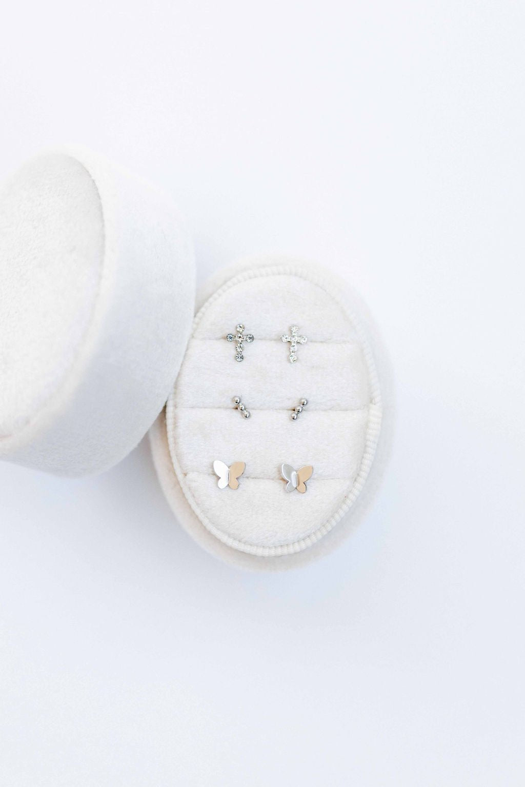 LINNY CO Micro Tally Silver screwback stud earrings for kids & little girls — hypoallergenic, waterproof stainless steel with secure screwback backs, flat-lay styling.