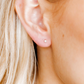 Close-up of an ear with a small Payton Pearl earring