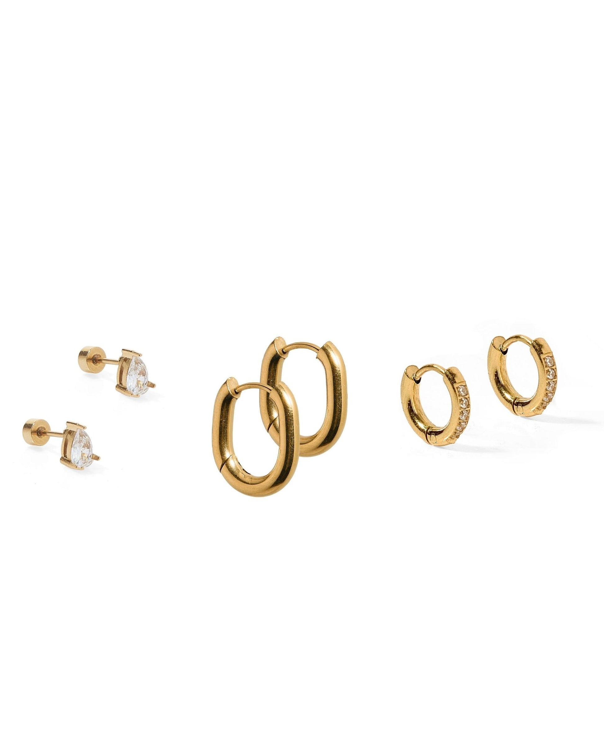 Set of gold hoop earrings on a white background