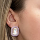 Close-up of an ear wearing a stud earring with a light purple frame and clear gemstone.