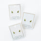 Three pairs of earrings on LINNY CO branded cards against a white background