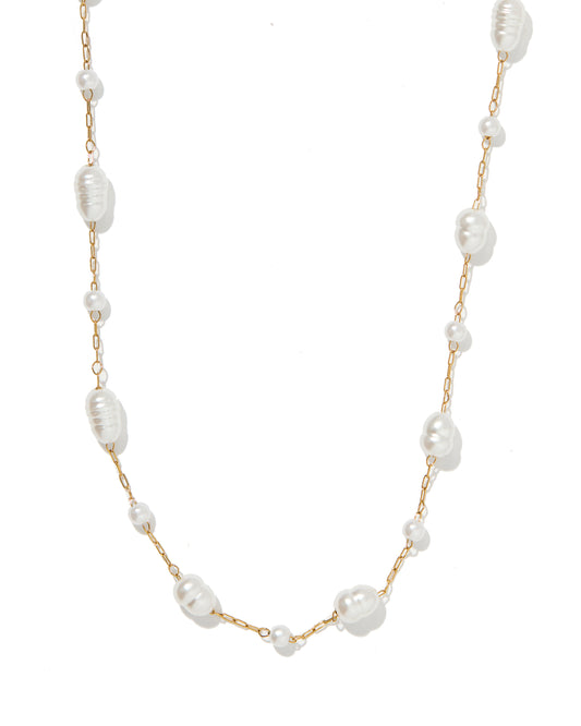 Pearl necklace with gold chain on a white background