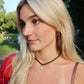 Woman with blonde hair and a red top in an outdoor setting linny co