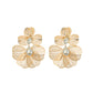 Gold floral earrings with clear gemstones on a white background