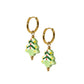 Gold hoop earrings with Christmas tree-shaped charms on a white background