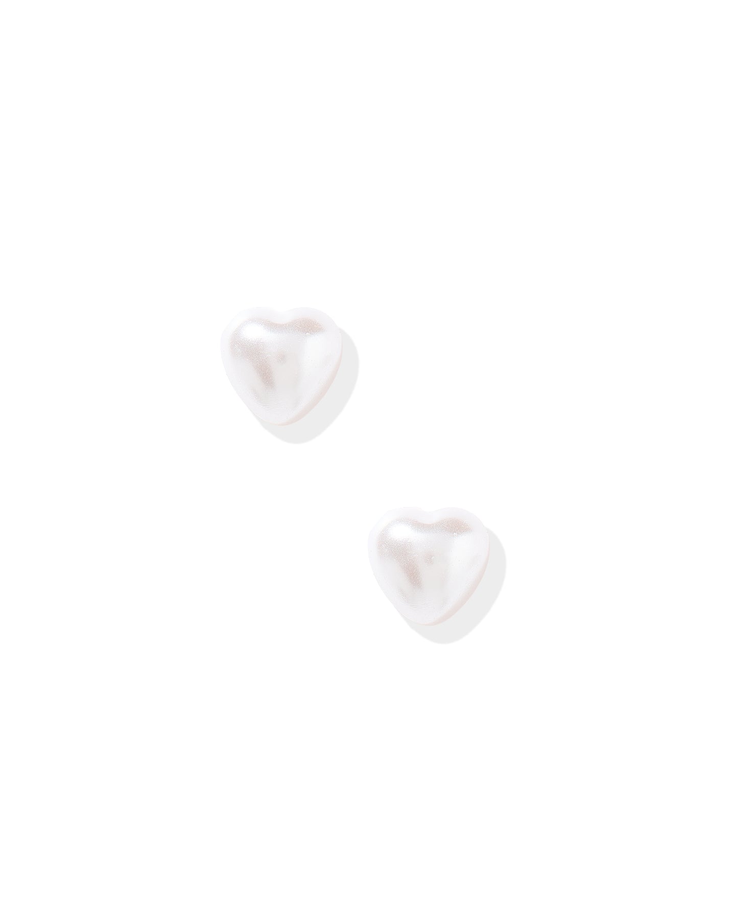 Pair of white heart-shaped earrings on a white background