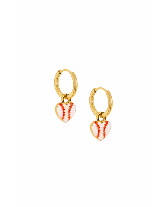 Gold hoop earrings with heart-shaped red and white enamel charms on a white background