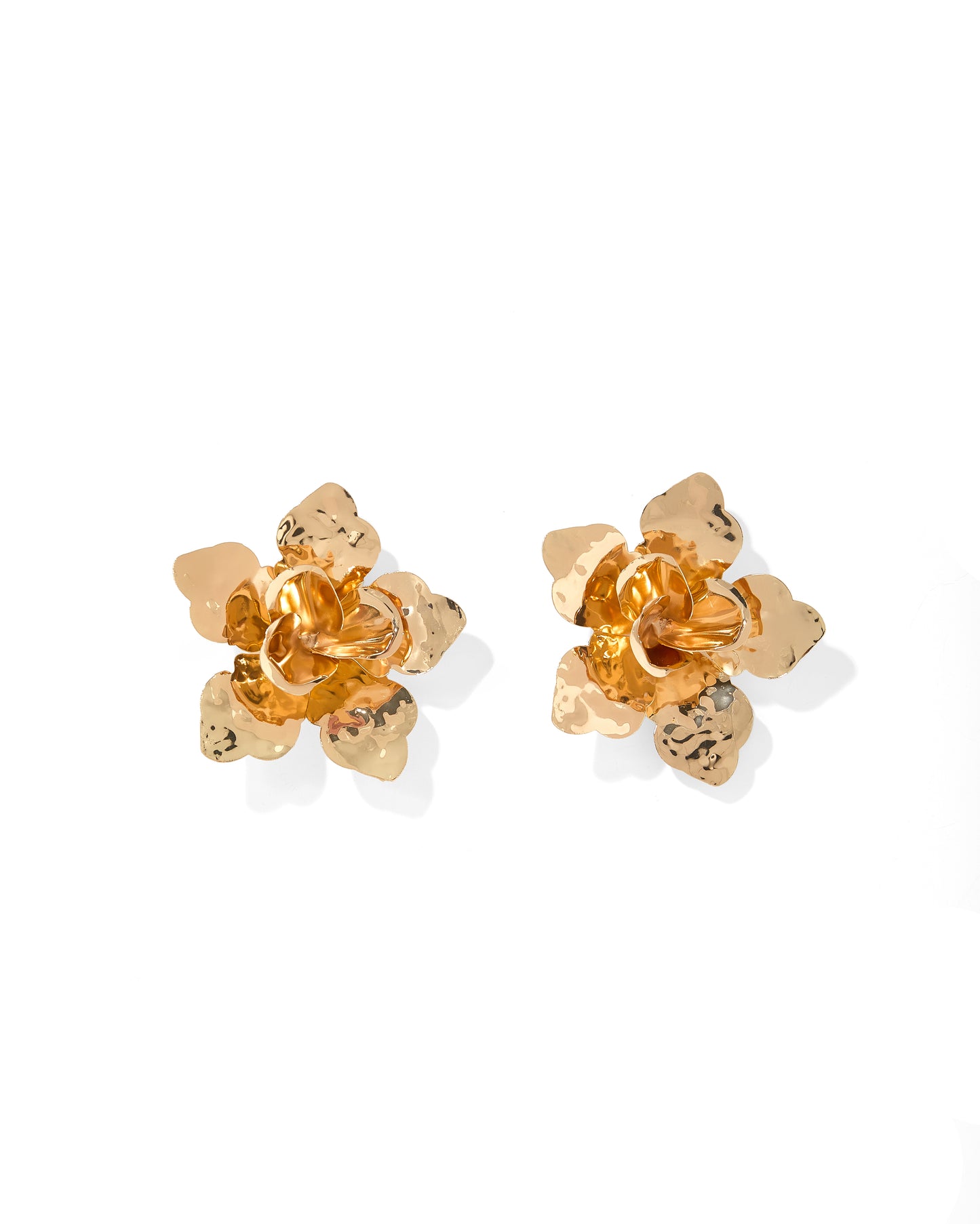 Pair of gold flower-shaped earrings on a white background