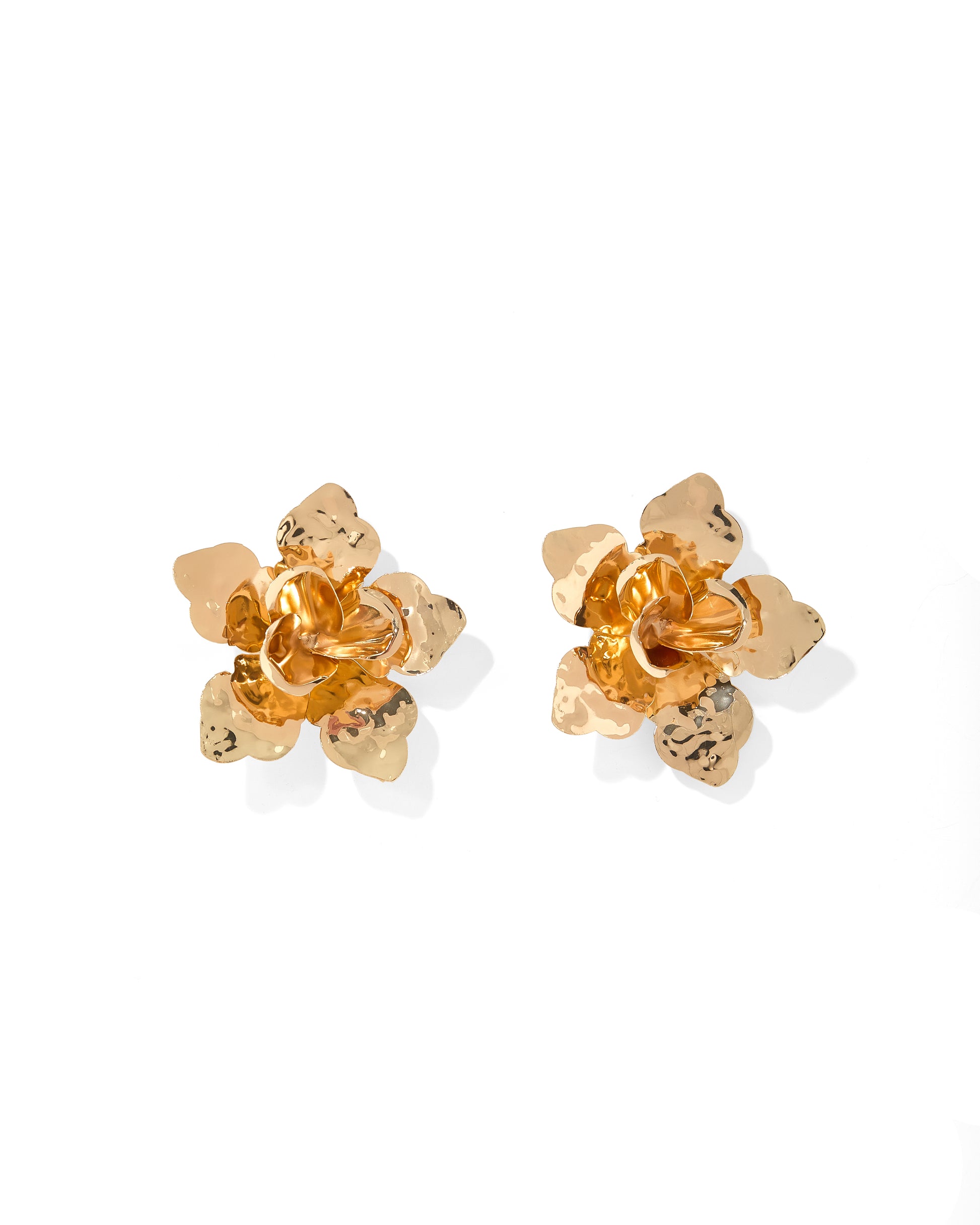 Pair of gold flower-shaped earrings on a white background