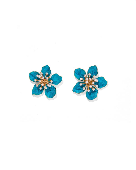 Pair of blue flower-shaped earrings on a white background