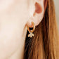 LINNY CO Amara Gold huggie earrings for kids & little girls — hypoallergenic, waterproof stainless steel, shown on model.