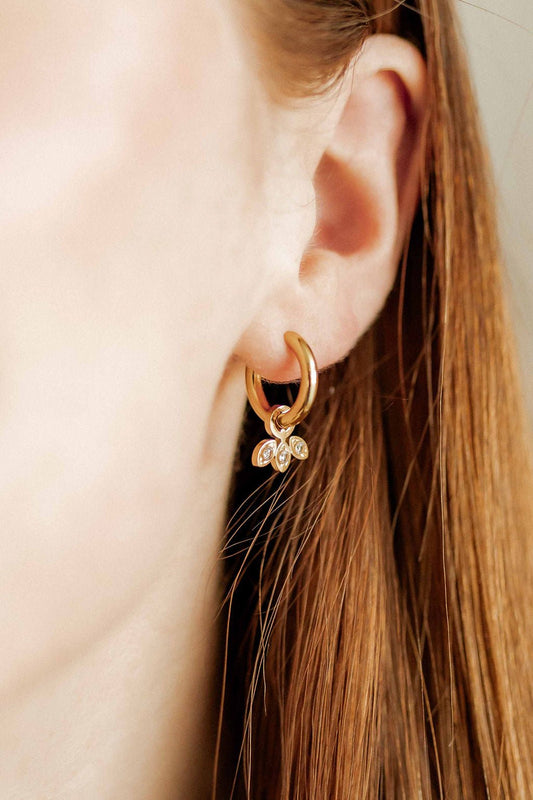 LINNY CO Amara Gold huggie earrings for kids & little girls — hypoallergenic, waterproof stainless steel, shown on model.
