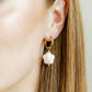 LINNY CO Bloom huggie earrings for kids & little girls — hypoallergenic, waterproof stainless steel, shown on model.