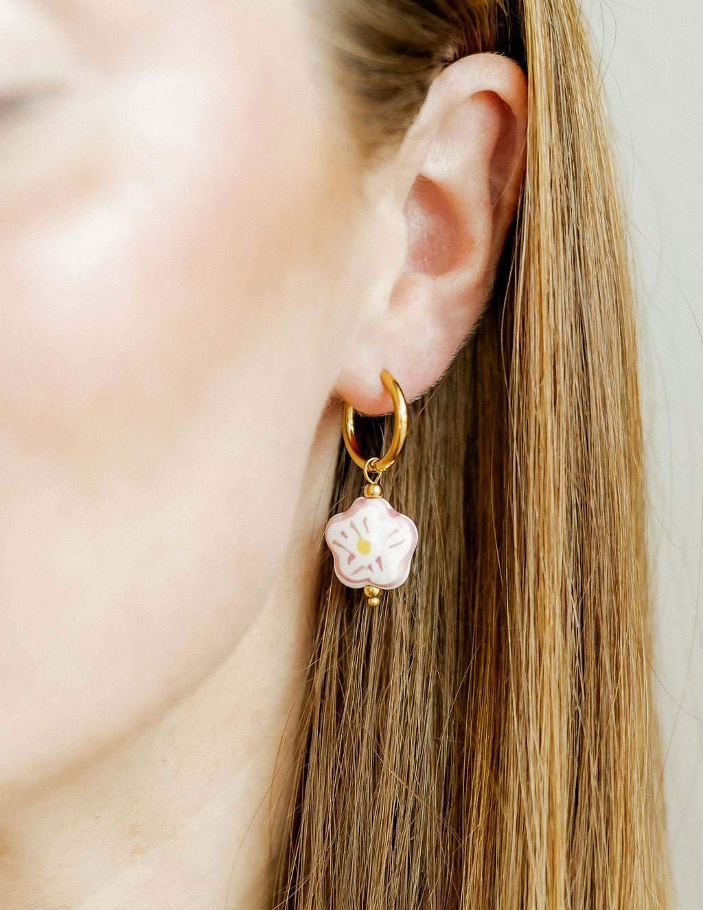 LINNY CO Bloom huggie earrings for kids & little girls — hypoallergenic, waterproof stainless steel, shown on model.