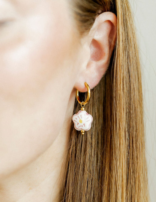 LINNY CO Bloom huggie earrings for kids & little girls — hypoallergenic, waterproof stainless steel, shown on model.