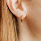 LINNY CO Celine Gold huggie earrings for kids & little girls — hypoallergenic, waterproof stainless steel, shown on model.