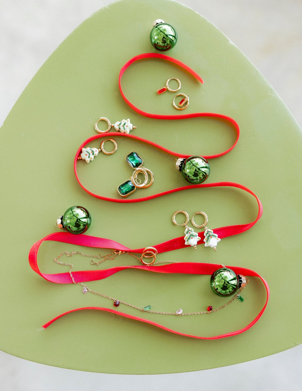 LINNY CO Diana Green huggie earrings for kids & little girls — hypoallergenic, waterproof stainless steel, flat-lay styling.