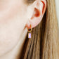 LINNY CO Edith Lavender Gold huggie earrings for kids & little girls — hypoallergenic, waterproof stainless steel, shown on model.