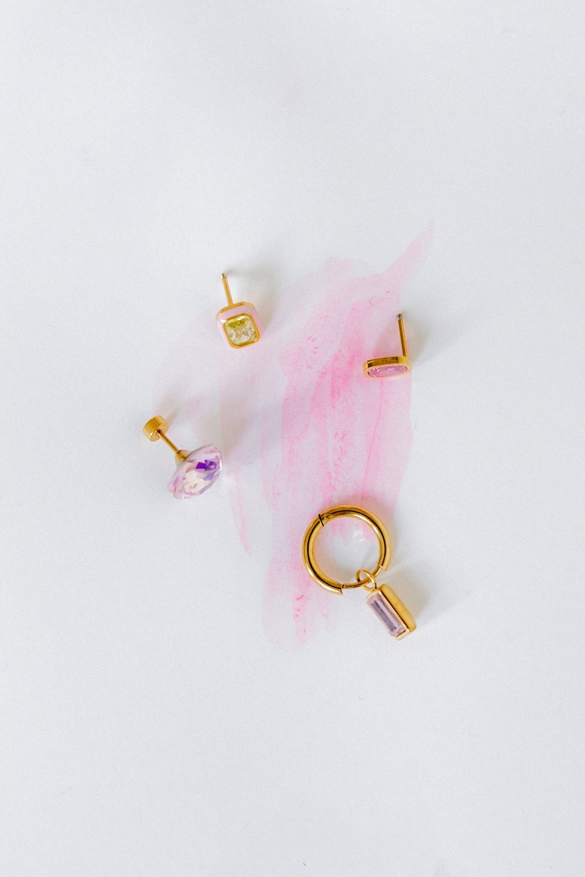 LINNY CO Edith Pink Gold huggie earrings for kids & little girls — hypoallergenic, waterproof stainless steel, flat-lay styling.
