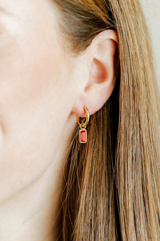 LINNY CO Edith Red Gold huggie earrings for kids & little girls — hypoallergenic, waterproof stainless steel, shown on model.