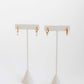 LINNY CO Jo Gold huggie earrings for kids & little girls — hypoallergenic, waterproof stainless steel, flat-lay styling.