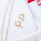 LINNY CO Jo Gold huggie earrings for kids & little girls — hypoallergenic, waterproof stainless steel, flat-lay styling.
