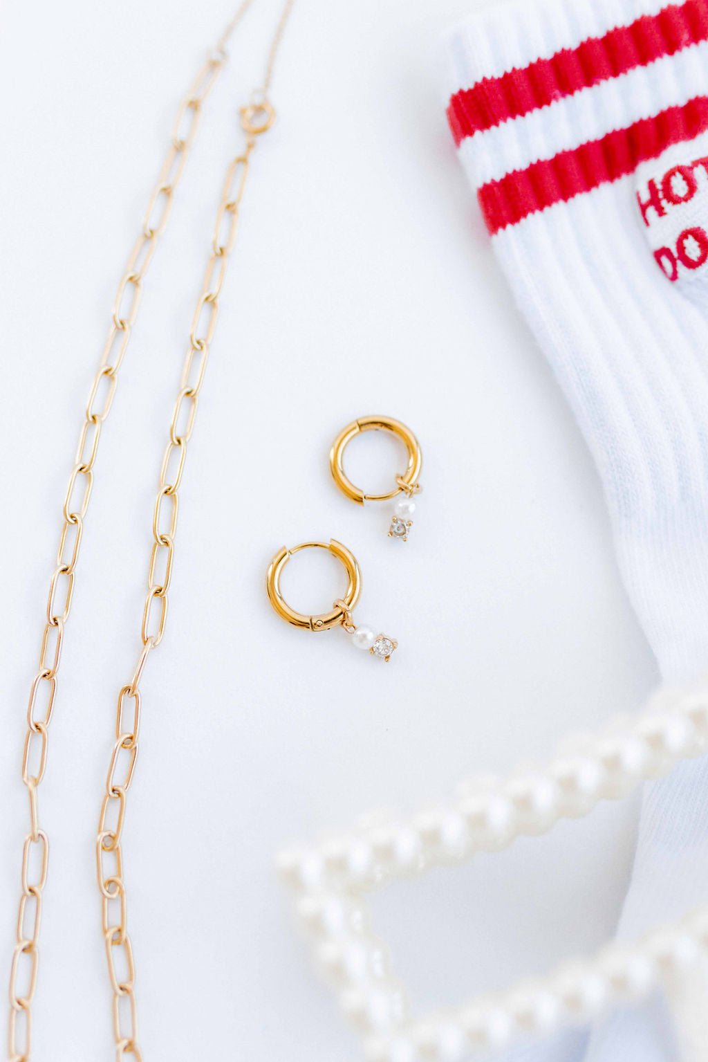 LINNY CO Jo Gold huggie earrings for kids & little girls — hypoallergenic, waterproof stainless steel, flat-lay styling.