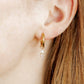LINNY CO Jo Gold huggie earrings for kids & little girls — hypoallergenic, waterproof stainless steel, shown on model.