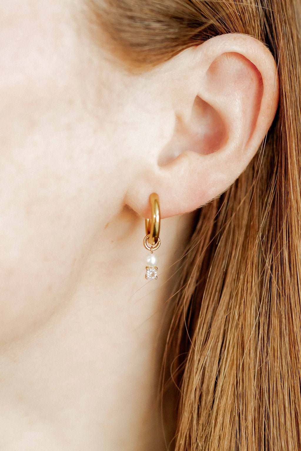 LINNY CO Jo Gold huggie earrings for kids & little girls — hypoallergenic, waterproof stainless steel, shown on model.