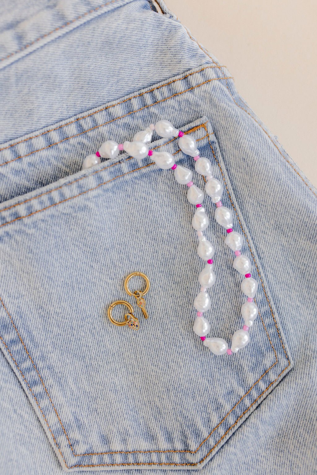 LINNY CO Lock and Key Gold huggie earrings for kids & little girls — hypoallergenic, waterproof stainless steel, flat-lay styling.