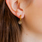 LINNY CO Lock and Key Gold huggie earrings for kids & little girls — hypoallergenic, waterproof stainless steel, shown on model.