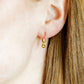 LINNY CO Nola 10mm huggie earrings for kids & little girls — hypoallergenic, waterproof stainless steel, shown on model.
