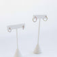 LINNY CO Scarlett Hoop Silver 10mm huggie earrings for kids & little girls — hypoallergenic, waterproof stainless steel, flat-lay styling.
