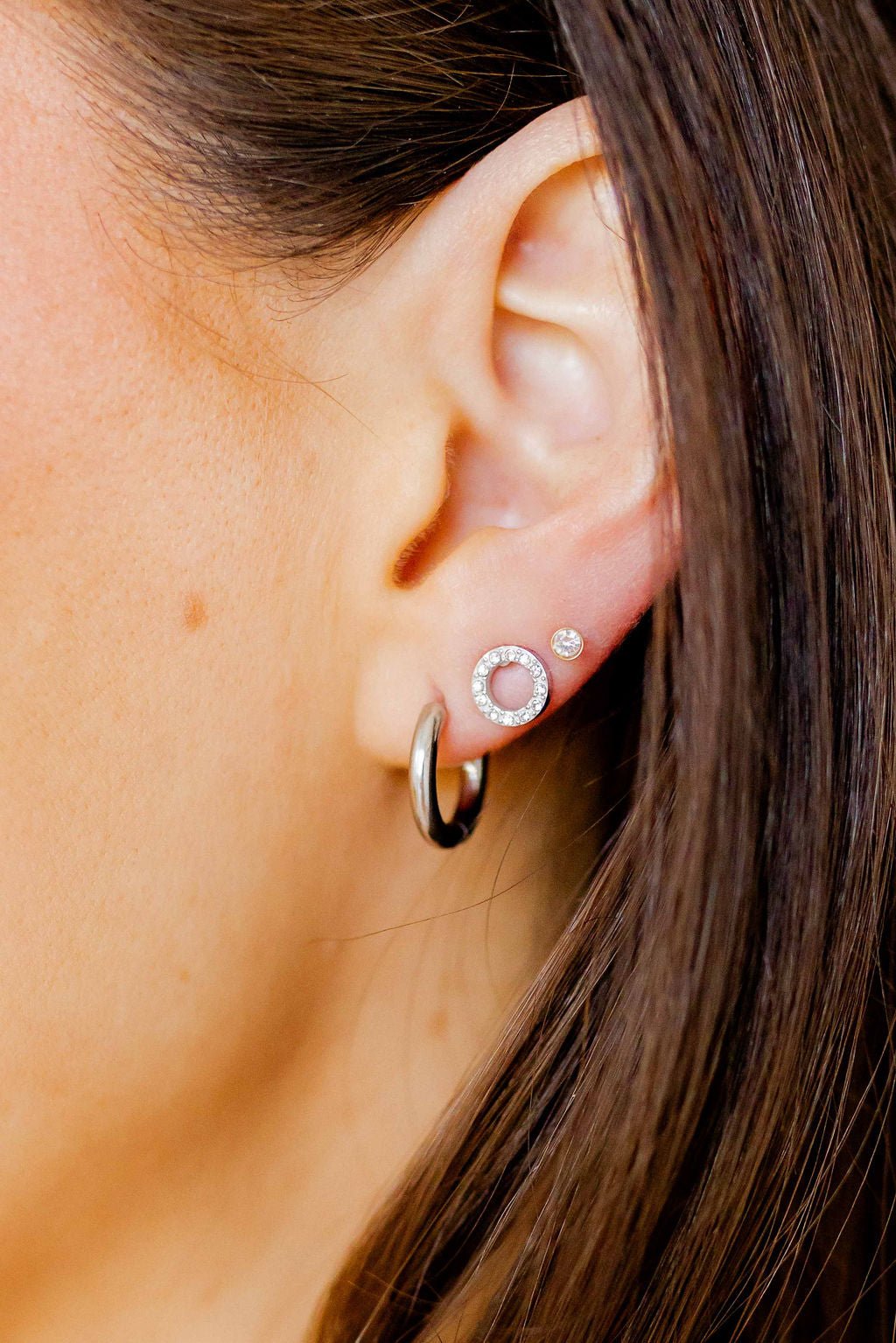 LINNY CO Scarlett Hoop Silver 10mm huggie earrings for kids & little girls — hypoallergenic, waterproof stainless steel, shown on model.