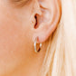 LINNY CO Scarlett Hoop Silver 14mm huggie earrings for kids & little girls — hypoallergenic, waterproof stainless steel, shown on model.